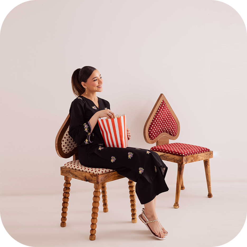 Woman wearing summer office fashion from BATIK, looking confident at work